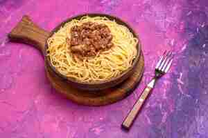 Foto gratuita spaghetti cucinati vista frontale con carne macinata su condimenti di pasta per piatti di pasta da tavola rosa