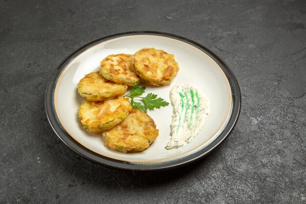 Front view cooked squashes slices inside plate on grey space