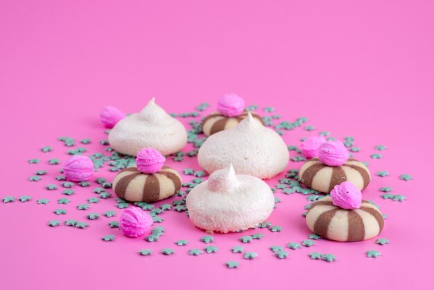 A front view cookies and meringues delicious and sweet on pink, cookie candy sugar sweet