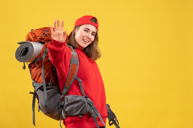 Front view cool female traveler with backpack giving high five