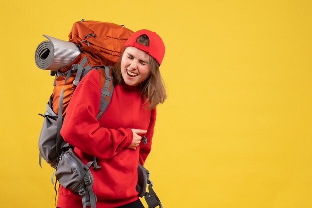 Front view cool female traveler with backpack holding stomach with pain