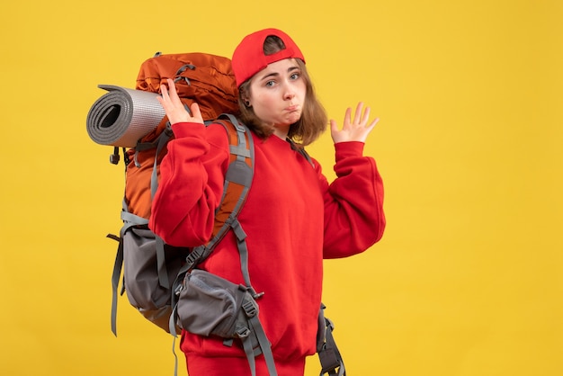 Front view cool female traveler with backpack wondering