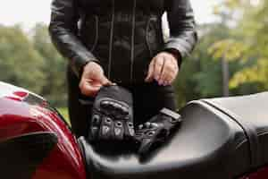 Free photo front view cool old woman with motorcycle