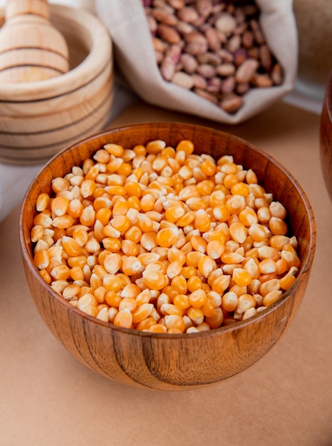 Front view corn grains in a bowl on a notebook