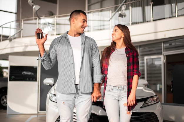 Front view couple at car dealership