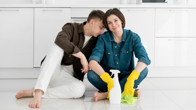 Front view of couple cleaning the house