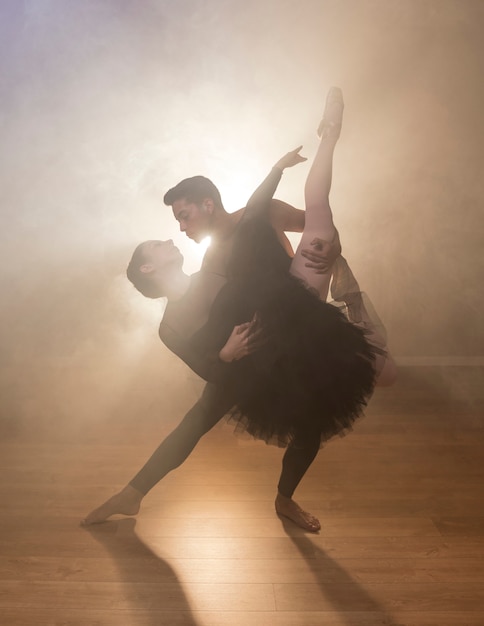 Front view couple dancing in smoke