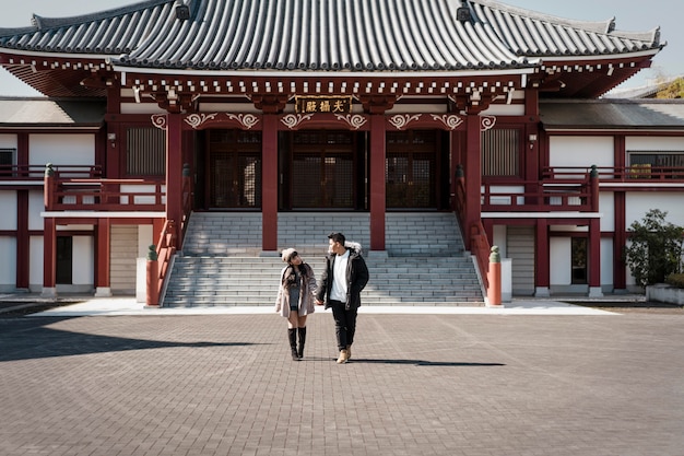 Front view of couple in front of japanese building