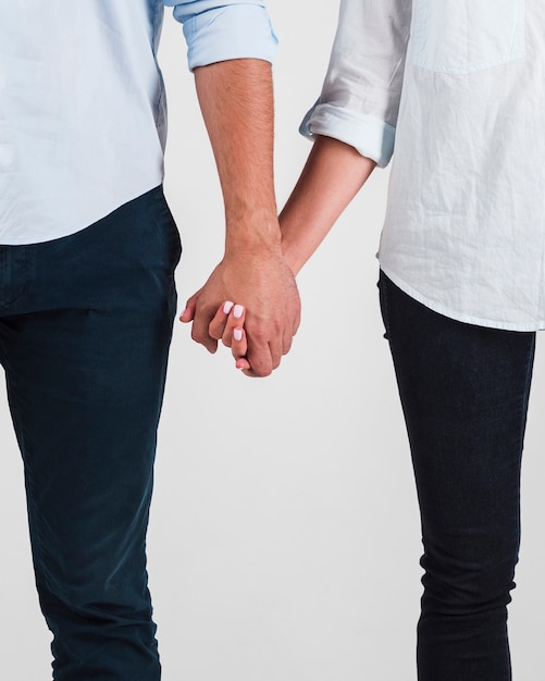 Free photo front view of couple holding hands