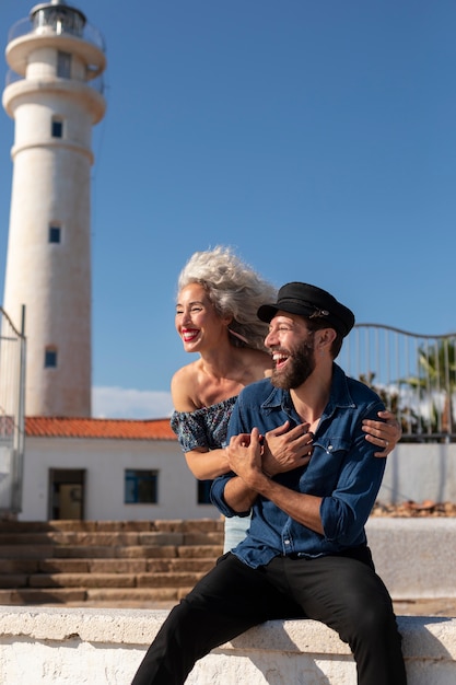 Free photo front view couple at the lighthouse