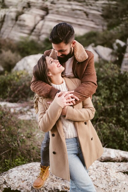 Front view couple looking at each other in nature