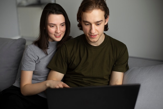 Front view of couple looking at laptop