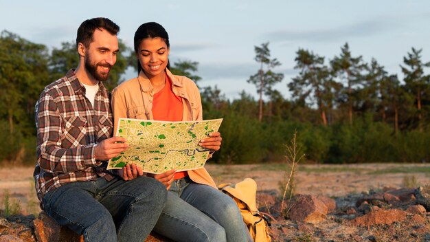 Front view couple looking together on a map