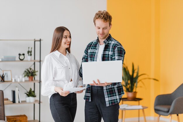 Front view of couple planning together to redecorate the household