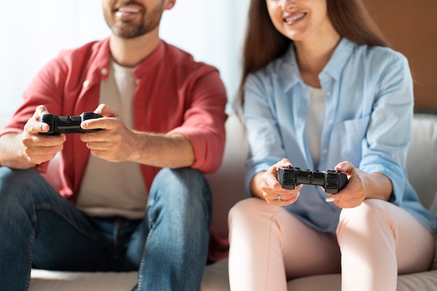 Front view couple playing videogame