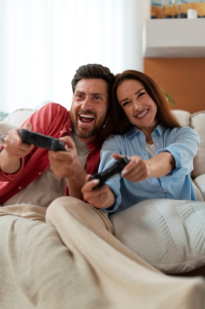 Front view couple playing videogame