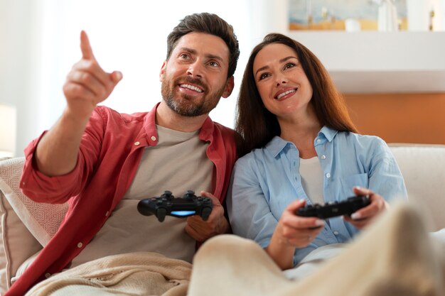 Front view couple playing videogame