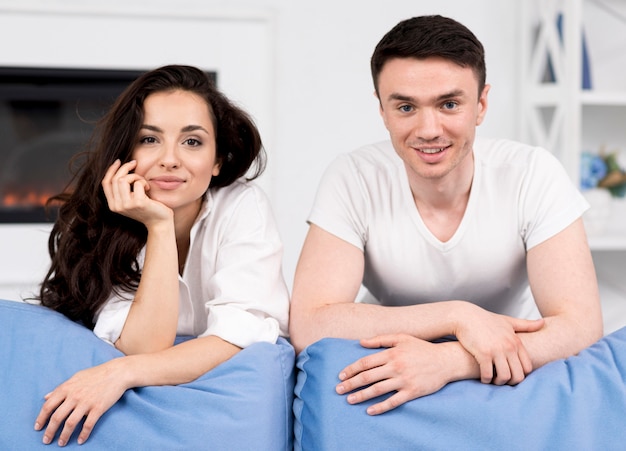 Front view of couple posing together on couch
