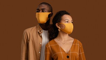 Front view of couple posing with face masks