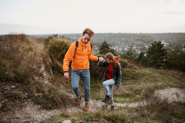 Front view of couple on a road trip in nature together