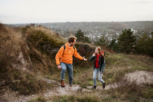 Front view of couple on a road trip together in nature