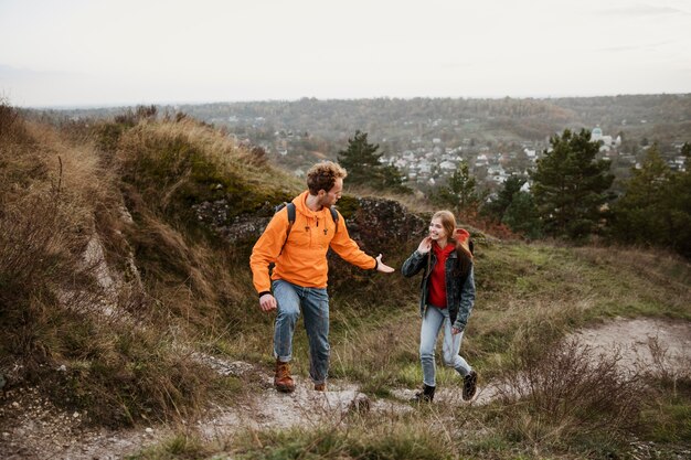 Front view of couple on a road trip together in nature