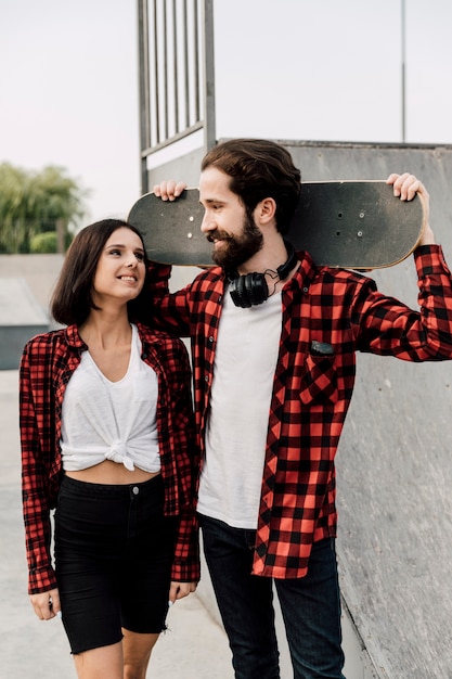 Front view of couple at skate park