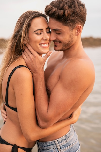 Front view of couple smiling and hugging