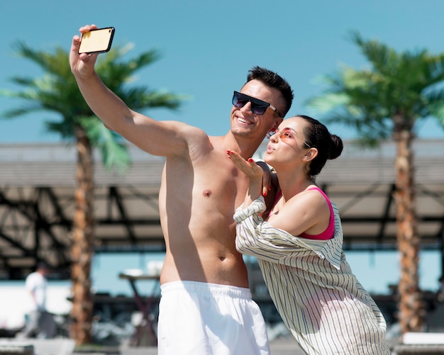 Free photo front view of couple taking a selfie