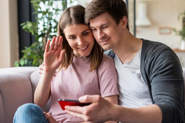 Front view of couple talking on videocall