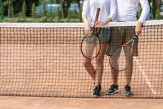 Front view couple on tennis court