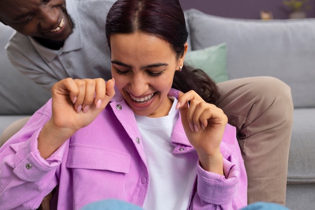 Free photo front view couple tickling at home