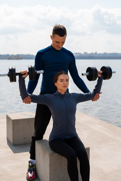 Front view couple training together outdoors