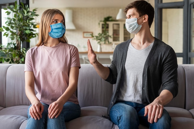 Front view of couple using medical mask