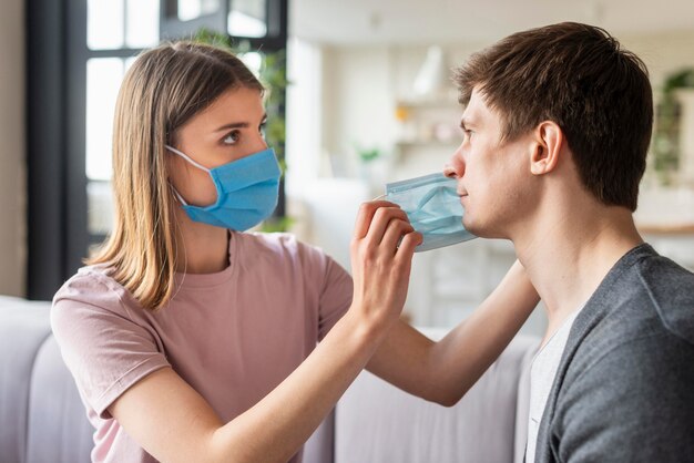 Front view of couple using medical mask