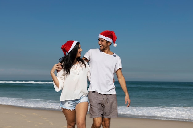 Free photo front view couple walking on beach