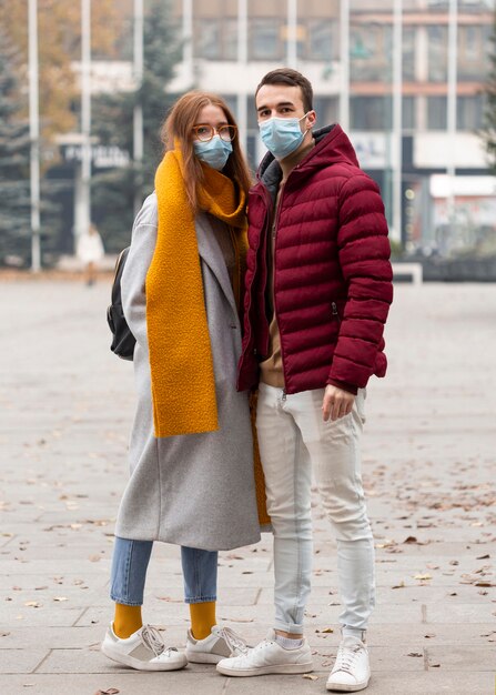 Front view of couple wearing medical masks