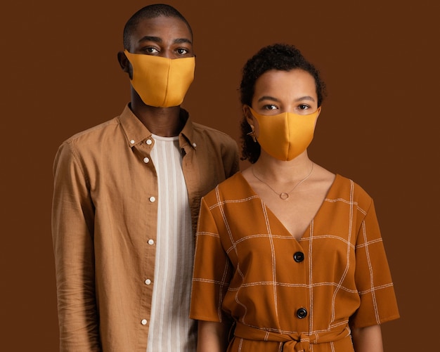 Free photo front view of couple with face masks