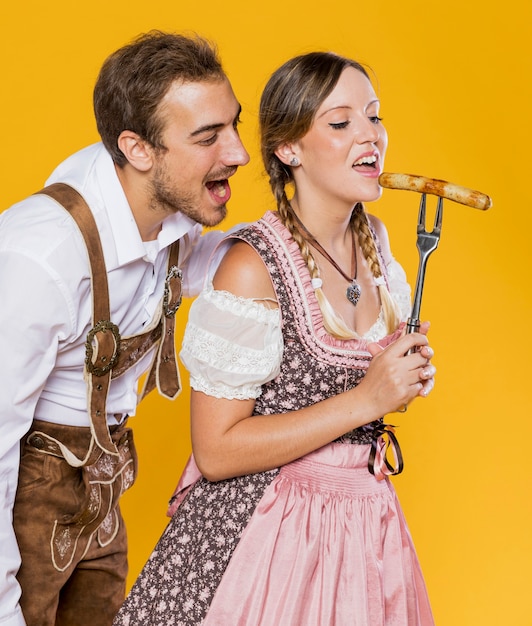 Free photo front view couple with a grilled sausage