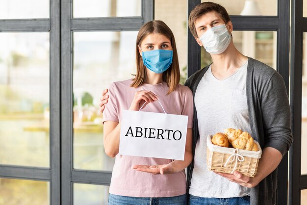 Front view of couple with open sign