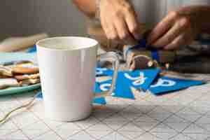 Free photo front view cup of coffee and happy hanukkah garland