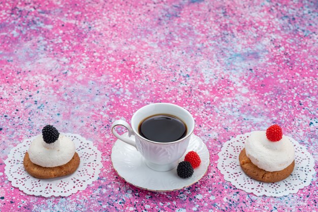 Front view of cup of coffee with cookies and cream on the colored surface