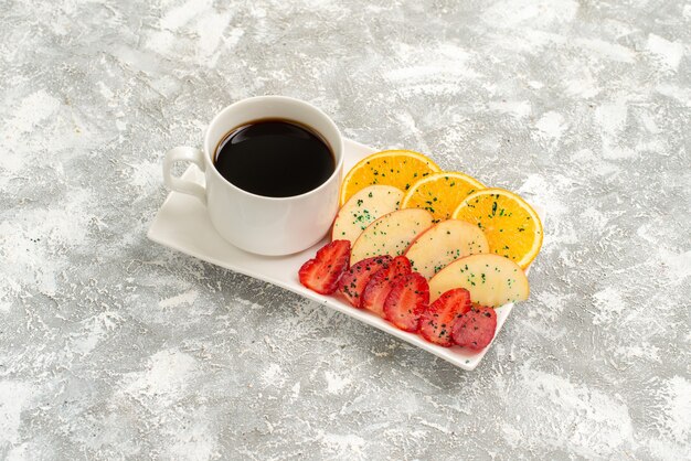 Front view cup of coffee with sliced apples oranges and strawberries on a light white background fruits ripe fresh mellow