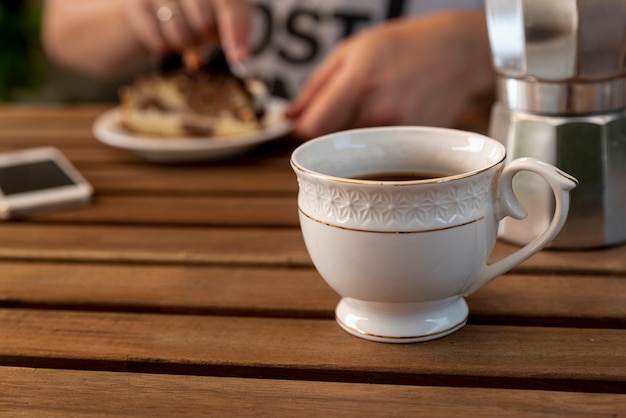 Front view cup of coffee on wooden table