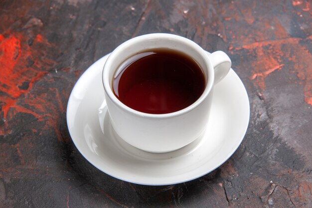 Front view cup of tea on a dark table color dark tea ceremony