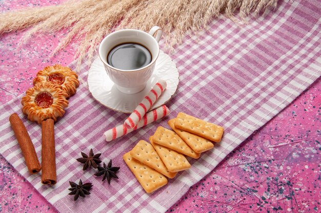 Front view cup of tea with cinnamon cookies and crackers on pink desk biscuit sugar sweet bake