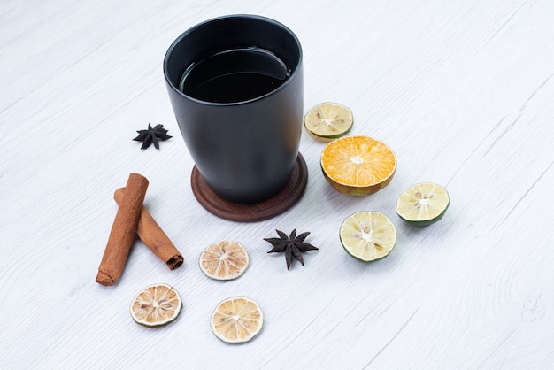 Front view cup of tea with cinnamon on white