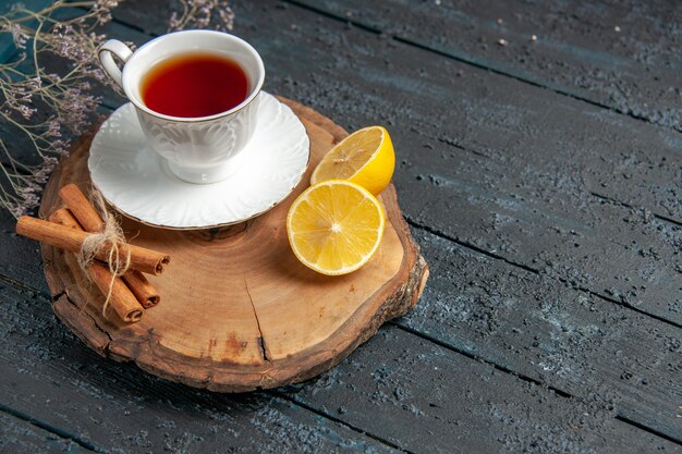 Front view cup of tea with lemon on a dark background