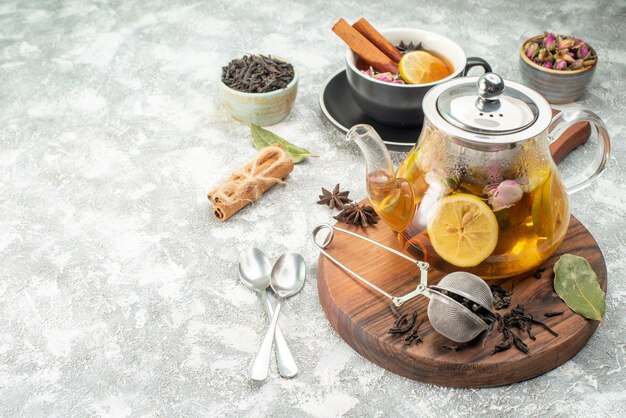 Front view cup of tea with lemon on light background flower color morning breakfast ceremony food fruit flavor