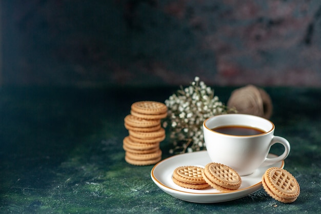 front view cup of tea with little sweet biscuits in white plate on dark background bread color ceremony breakfast morning drink sugar photo